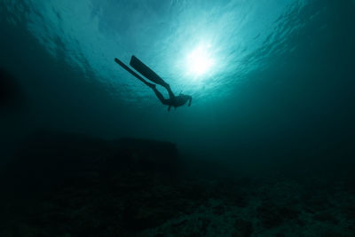 Woman scuba diving in sea