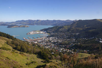 High angle view of townscape by mountains against clear sky