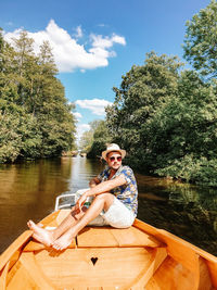 Smiling man sitting on boat in lake