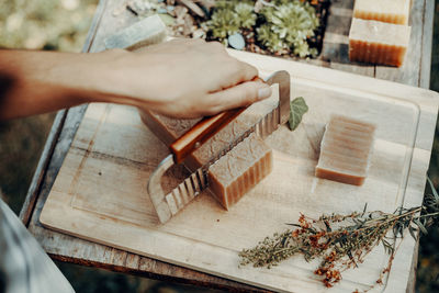 Cropped hand of man working on wood