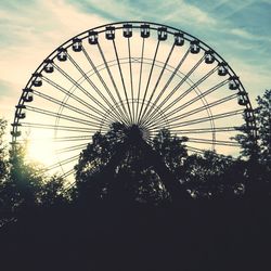 Low angle view of ferris wheel against sky