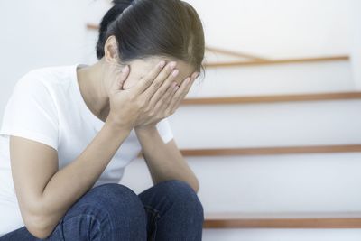 Midsection of woman sitting on floor