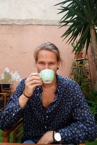 Portrait of young woman holding drink