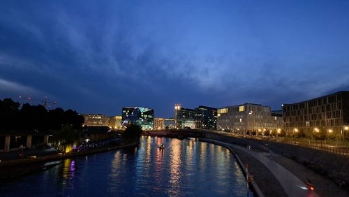 Bridge over river against sky at night
