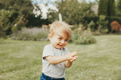 Close-up of boy standing on field