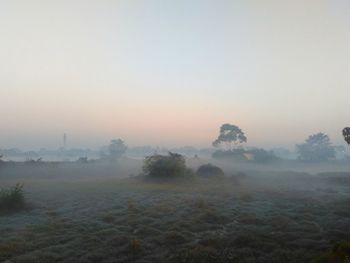 Scenic view of landscape against sky at sunset