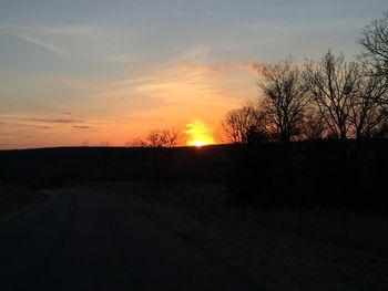 Silhouette bare trees against sky during sunset