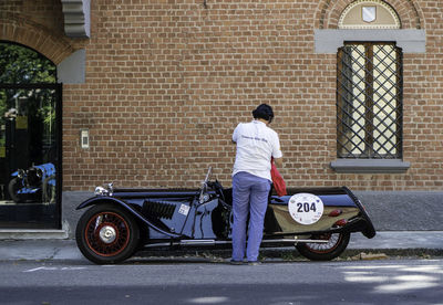 Rear view of man with umbrella on street