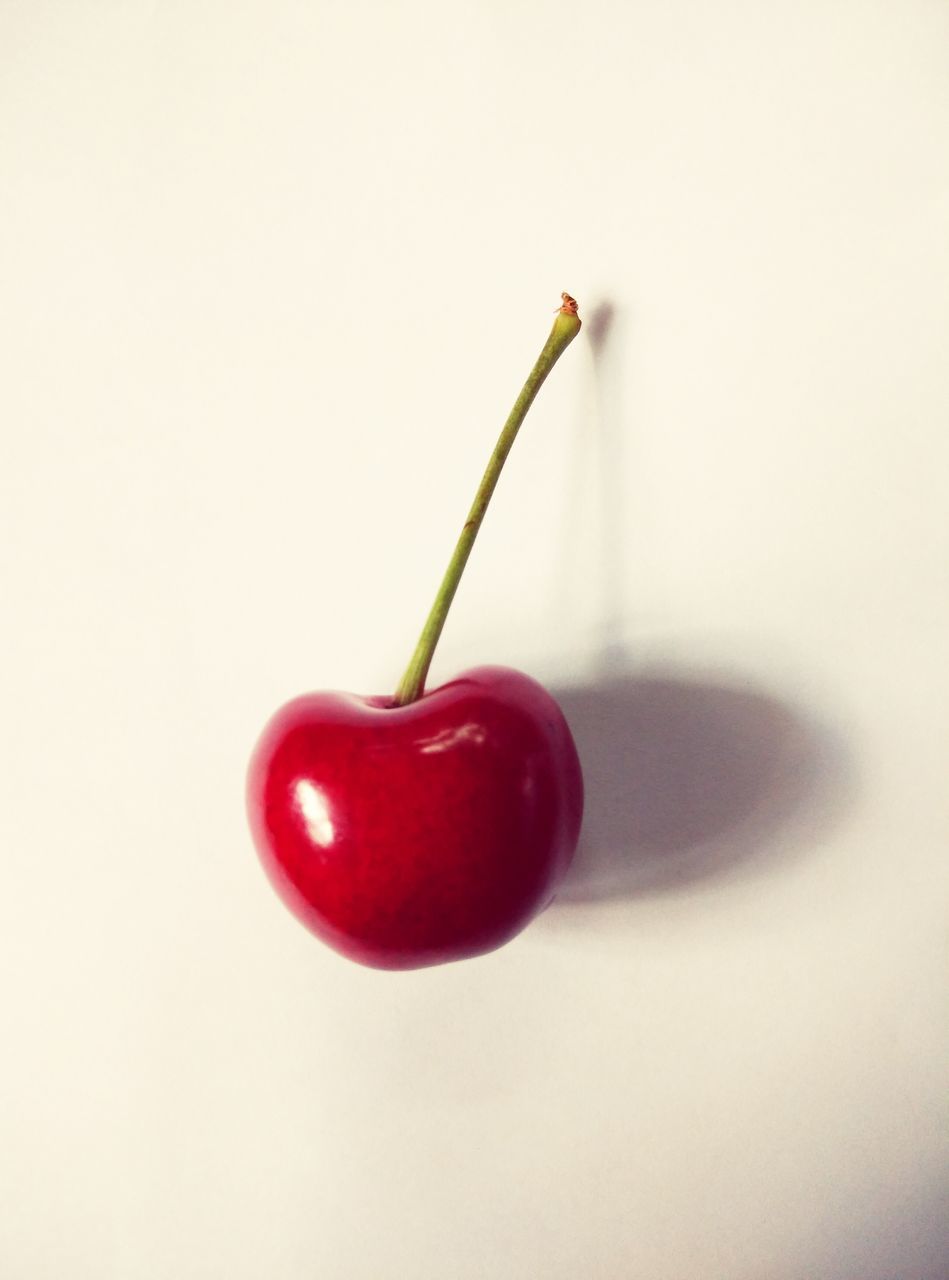 red, studio shot, food and drink, still life, white background, freshness, fruit, food, close-up, healthy eating, single object, cherry, indoors, copy space, three objects, no people, ripe, stem, cut out, table