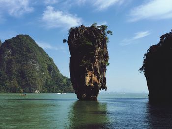 Scenic view of rock formation in sea against sky