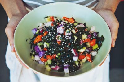 Chef holding bowl with seaweed salad