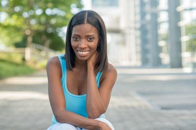 Portrait of smiling young woman standing outdoors