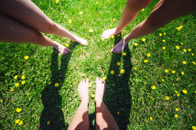 Low section of women standing on field