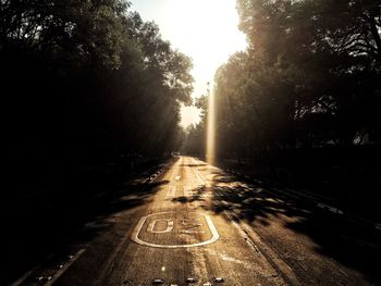 Road amidst trees against sky