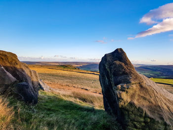 Scenic view of rocks on land against sky