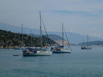 Sailboats sailing on sea against sky