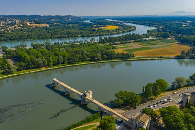 High angle view of river amidst trees against sky