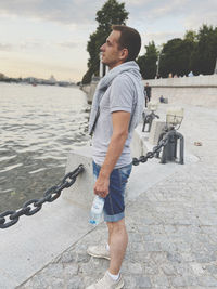 Full length of young man standing in water