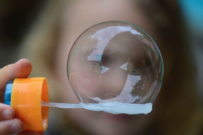 Close-up of person holding bubble