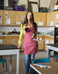Portrait of smiling drawing teacher in classroom