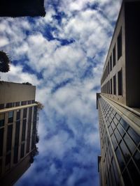 Low angle view of building against cloudy sky