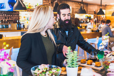 Man and woman having food in bar