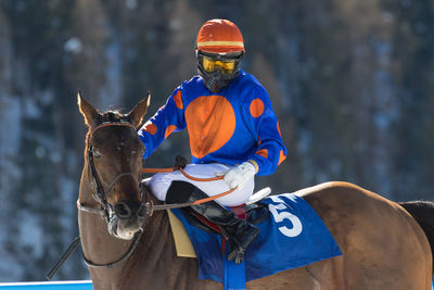 Midsection of man riding horse