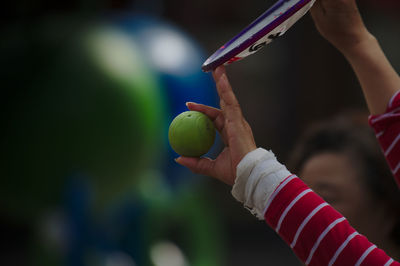 Close-up of boy playing with ball