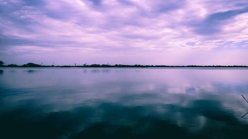 Scenic view of lake against sky at sunset
