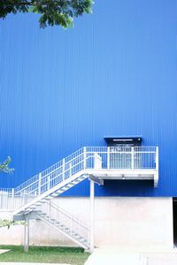 Swimming pool by building against clear blue sky