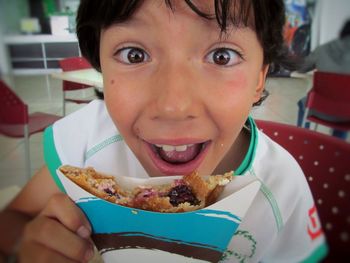 Portrait of boy eating sweet food