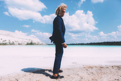 Full length of woman standing on land against sky