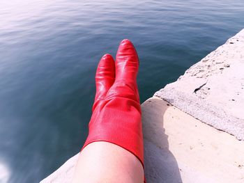 Low section of woman in red boots