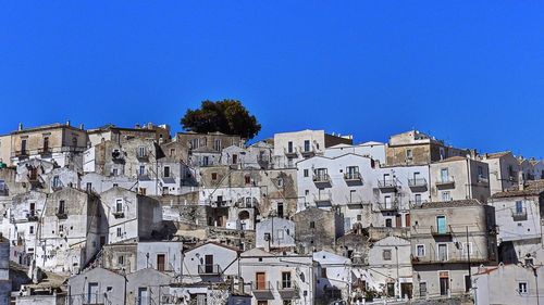 Low angle view of town against clear blue sky