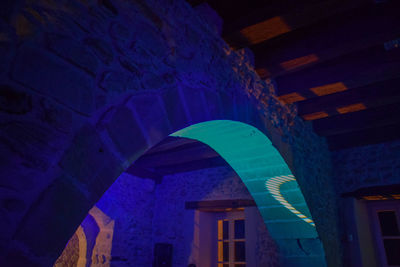 Low angle view of illuminated built structure at night