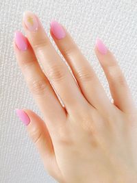 Cropped image of woman showing pink nail polish