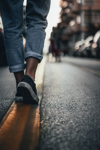 Low section of person standing on street