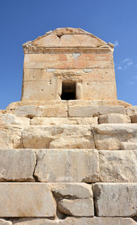 Low angle view of historical building against blue sky