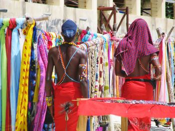 Rear view of men standing in market