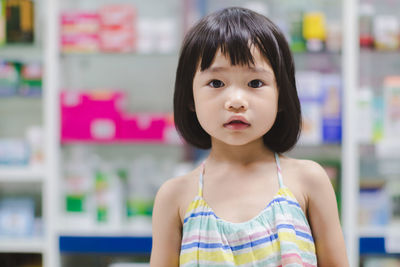 Portrait of cute girl standing in supermarket 