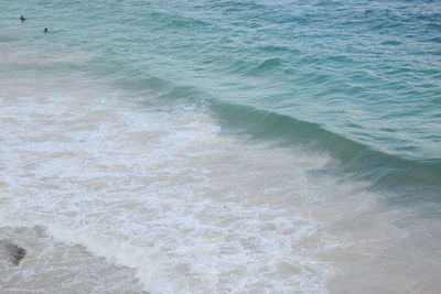 High angle view of waves rushing towards shore