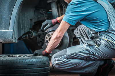 Midsection of man working in workshop