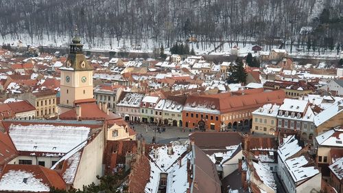 High angle view of townscape by snow covered houses in winter