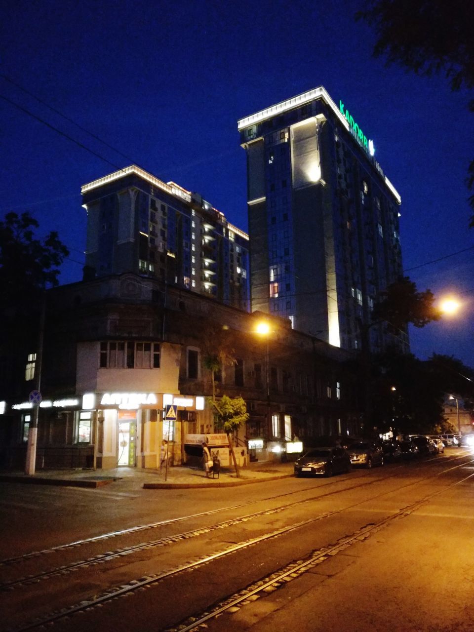 night, architecture, illuminated, building exterior, built structure, evening, city, street, lighting, transportation, light, urban area, sky, road, dusk, building, no people, darkness, mode of transportation, street light, downtown, nature, cityscape, house, car, motor vehicle, outdoors, city street, tree