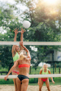 Female team playing beach volleyball