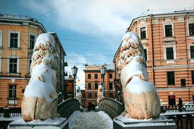 Statue against sky in city