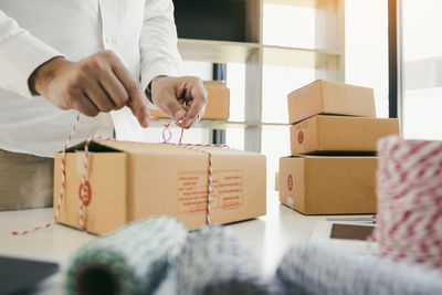 Midsection of man holding camera in box