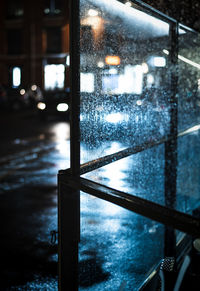 Reflection of illuminated wet window in rainy season