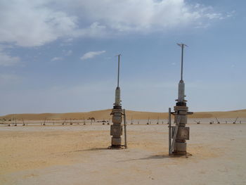 Built structure on beach against sky