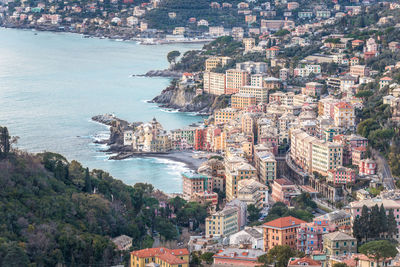 High angle view of cityscape by sea against sky